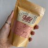Handmade vegan friendly bath crumble / dust. It is packaged in a eco friendly kraft pouch. This product is red, named Ddraig and scented in strawberry or hapus.